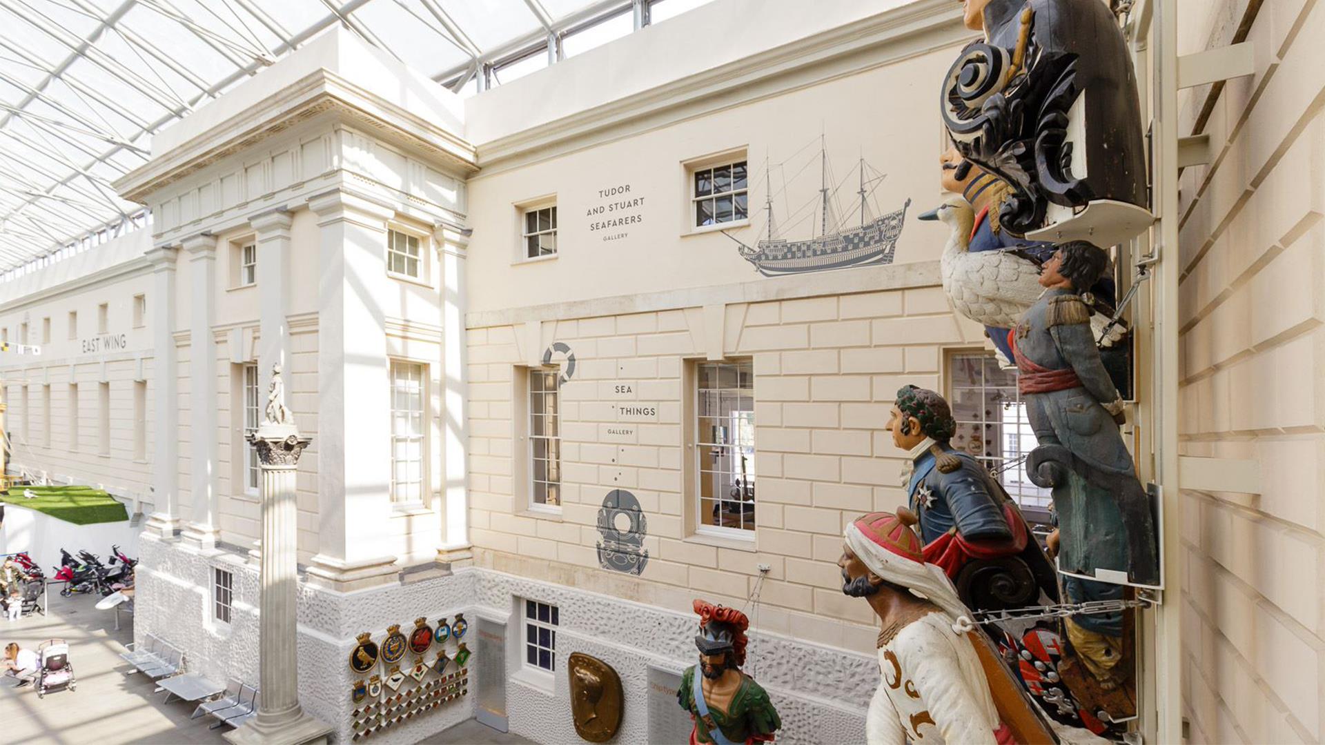 A wall of figureheads overlook the galleries at the National Maritime Museum in Greenwich.
