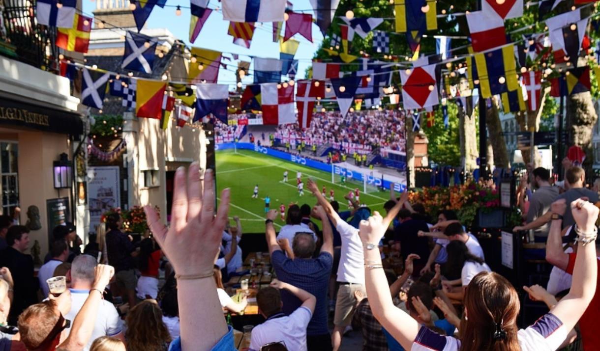 People watching the football on a big screen outside Trafalgar Tavern in Greenwich