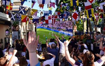 People watching the football on a big screen outside Trafalgar Tavern in Greenwich