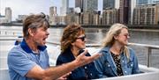 Family enjoying a Thames River Sightseeing cruise on the River Thames