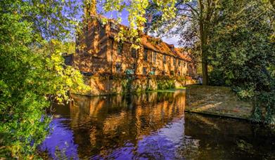 Looking over the moat, at the beautiful Tudor Barn on a sunny day