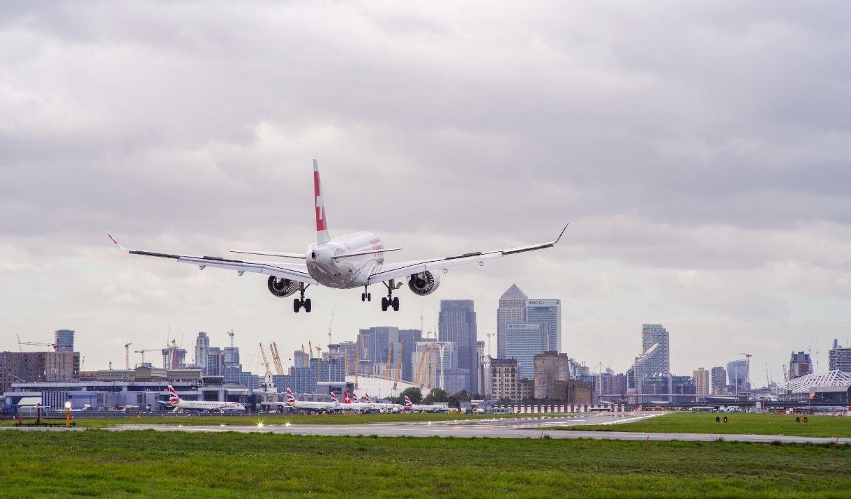 A plane comes in to land at London City Airport with Canary Wharf in the background. A plane comes in to land at London City Airport with Canary Wharf in the background.